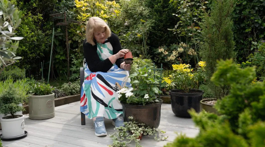 A woman sat gardening