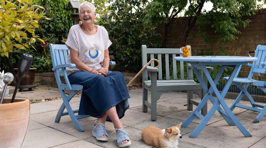 A woman sat in a garden with her dog