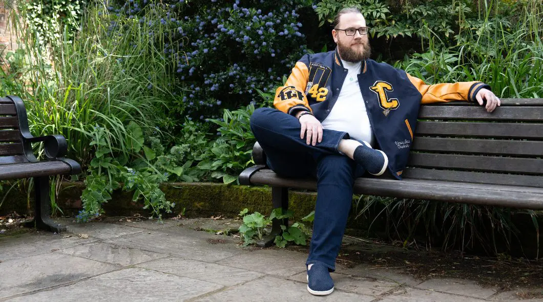 A man sat on a park bench