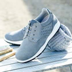 A pair of sky blue lace trainers on a wooden table