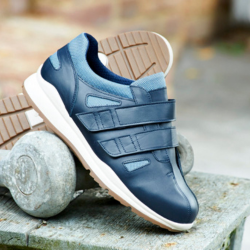 A pair of blue strapped trainers with a white sole