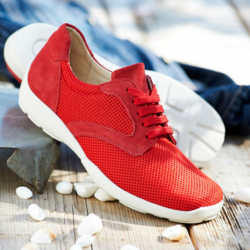 A pair of red laced trainers